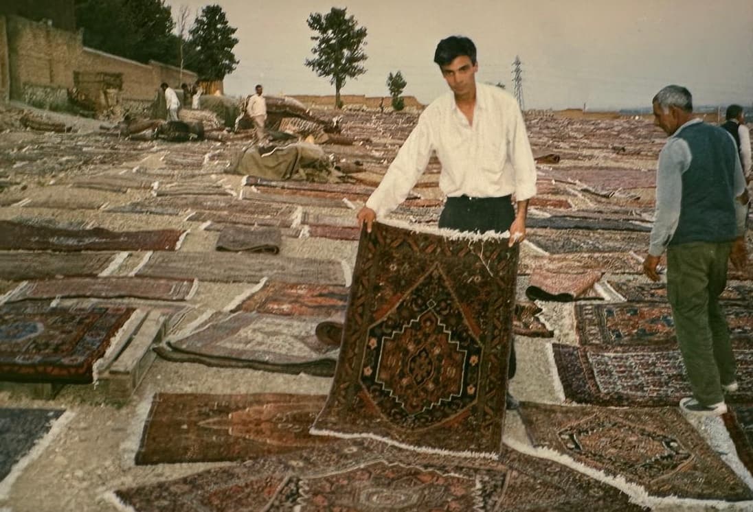 Young founder holding a rug in Iran